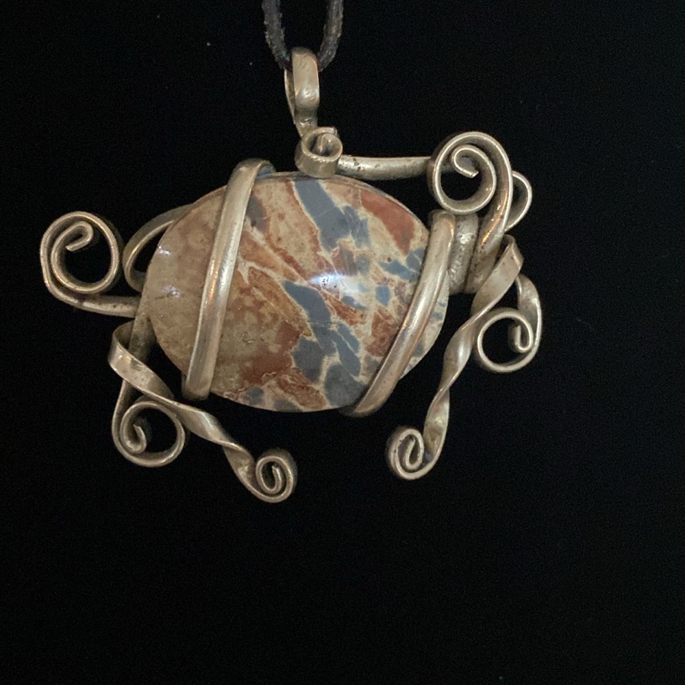 Beautiful Brecciated Jasper stone wrapped in silver on leather lariat.